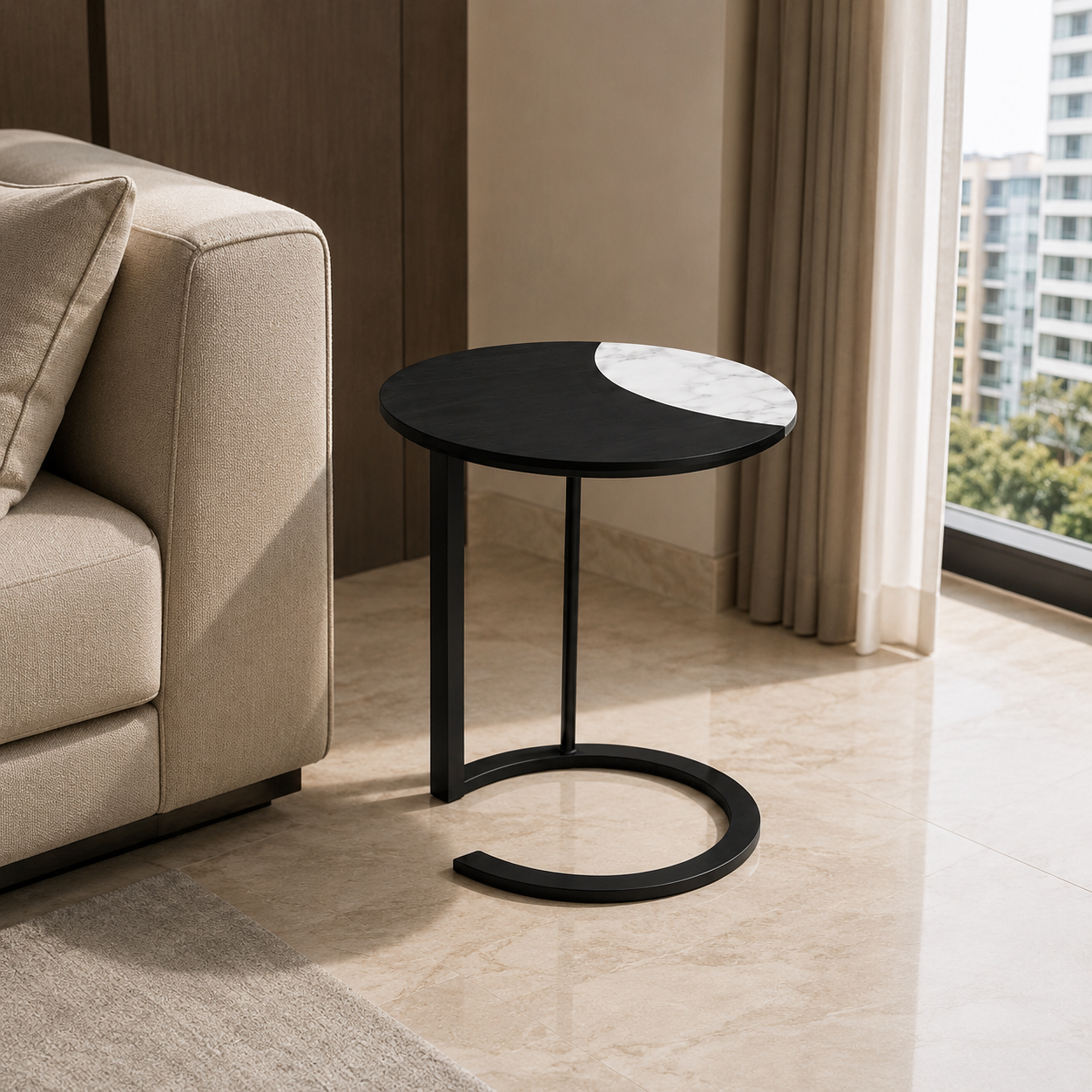 A modern round side table with a black metal frame and a split black-and-white marble top, styled in a contemporary living room next to a beige sofa.