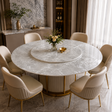 A round white marble dining table with a matching rotating top, surrounded by eight cream upholstered dining chairs with gold legs, set in a luxurious modern dining room.