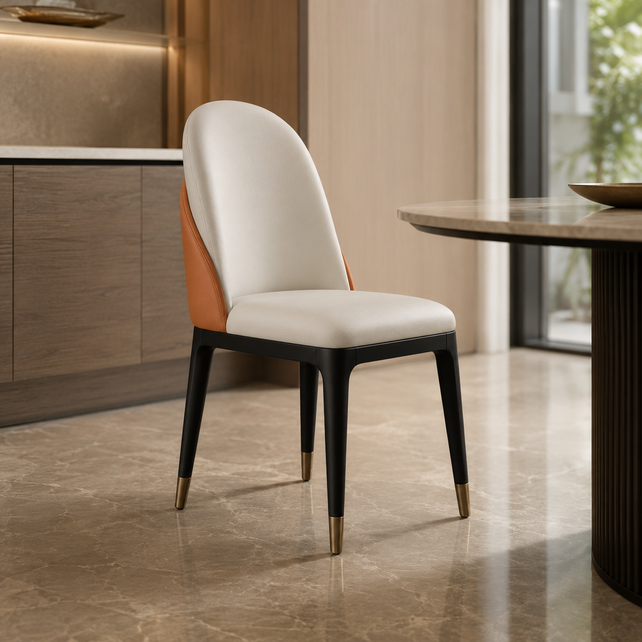 A modern dining chair with a curved white upholstered back and seat, orange side panels, and black legs with gold-tone tips, shown in a contemporary dining room setting.