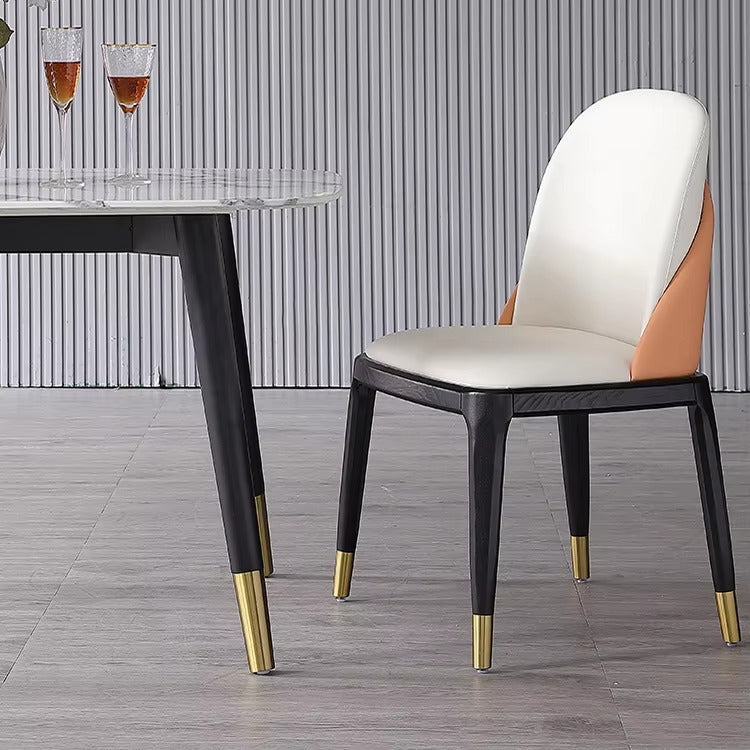 Modern chair with white cushion and black frame on a wooden floor.