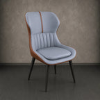 Chair with blue cushion and brown accents against a gray wall