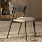 Modern chair with a neutral color scheme on a carpeted floor.