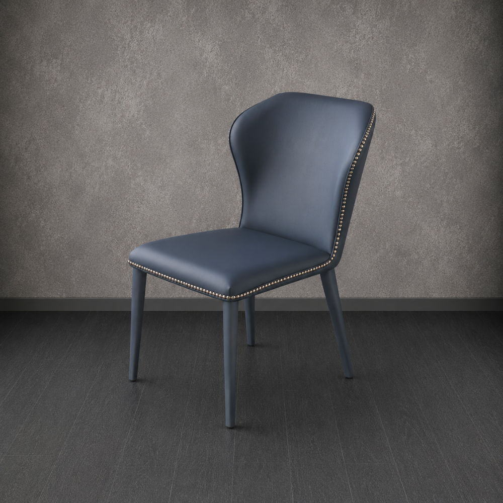 Blue chair with studded details against a gray wall