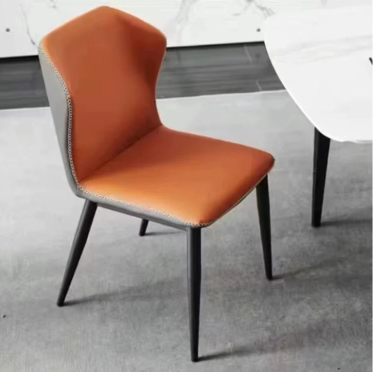 Orange chair with black legs on a gray floor