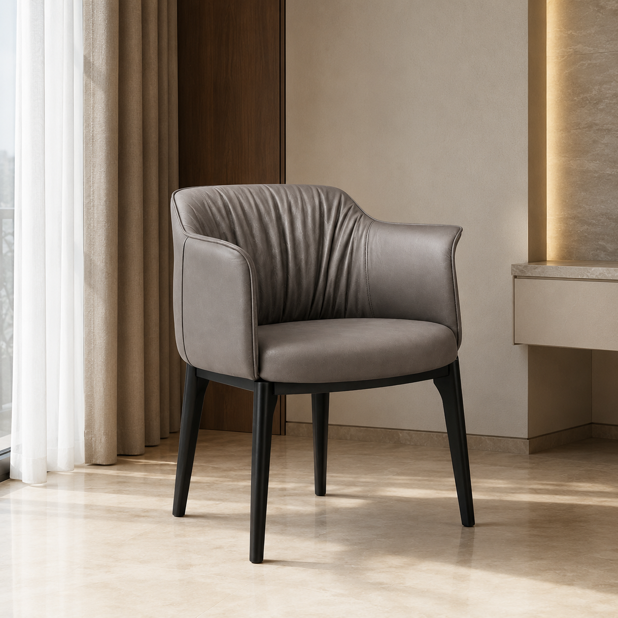 A modern gray upholstered accent chair with a curved backrest, black wooden legs, and a low rounded armrest, shown in a minimalist interior setting with beige walls, curtains, and a light wood floor.