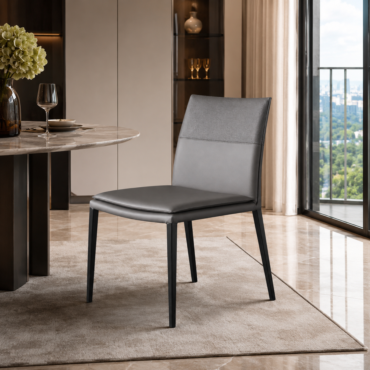 A modern gray upholstered dining chair with black legs, positioned in a stylish dining room setting next to a marble table and a large window with a city view.
