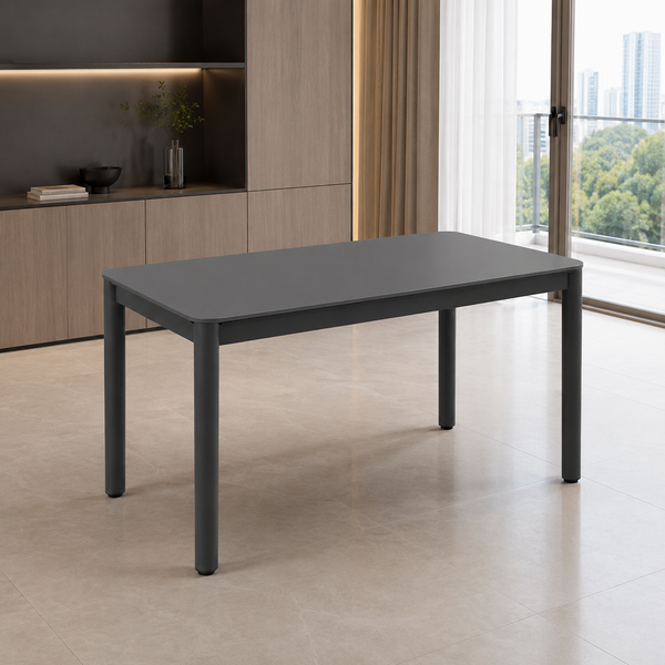 A dark gray rectangular dining table with slim legs, shown in a modern room setting with light wood cabinetry, beige tiled flooring, and a large window with a view of trees and buildings.