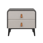 A two-drawer nightstand with a light beige leather front, dark gray faux-leather sides and top, and black legs, featuring small brown leather pull tabs.