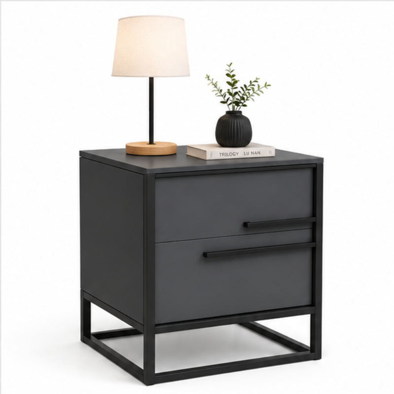 A modern two-drawer nightstand with a matte dark gray finish and black metal frame, styled with a table lamp and a small potted plant on top, set against a plain white background.
