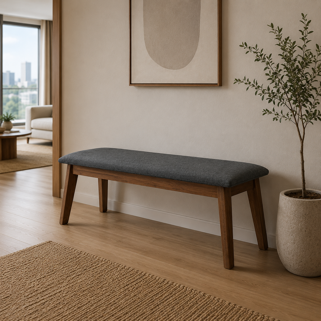 Wooden bench with a gray cushion in a living room setting with a plant and framed art on the wall.