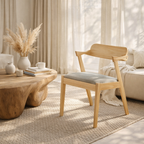 Wooden chair with a cushion in a living room setting with a wooden coffee table and decorative items.