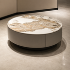 Round coffee table with marble top and beige base in a room setting