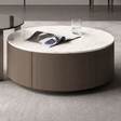Round coffee table with a magazine and glass on a gray carpet