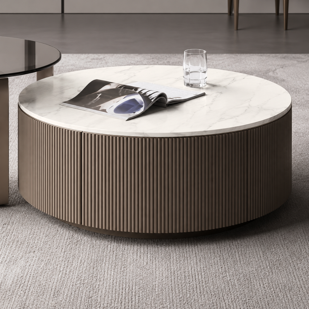Round coffee table with a magazine and glass on a gray carpet