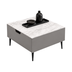 A modern square coffee table with a light gray and white marble top, a matte gray body, and tapered black legs. A black tray with a black bottle and bowl is placed on top of the table against a plain white background.