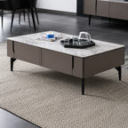 Modern coffee table with a marble top and dark base in a room setting.