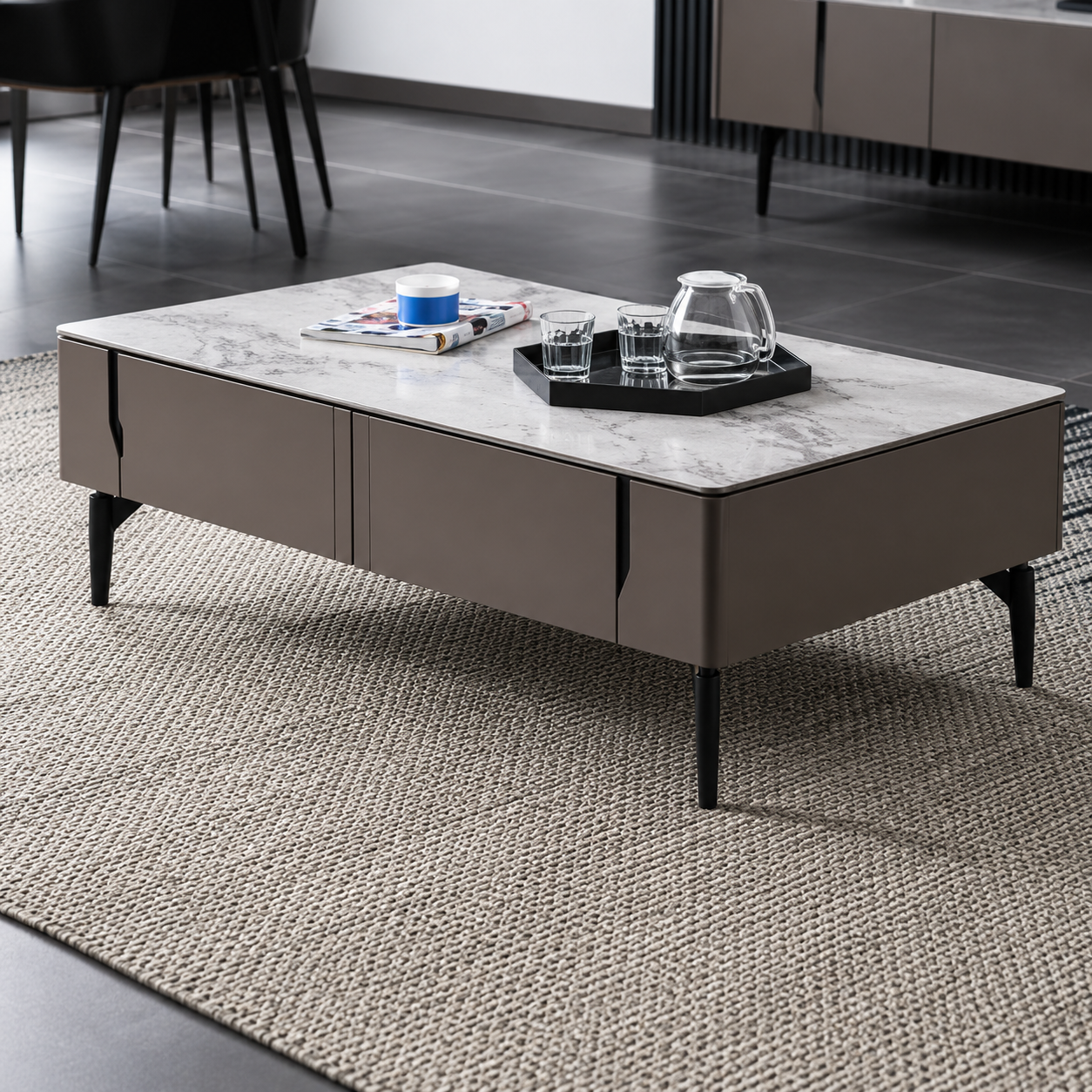 Modern coffee table with a marble top and dark base in a room setting.