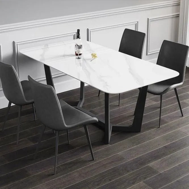 Dining table with chairs in a room with wainscoting