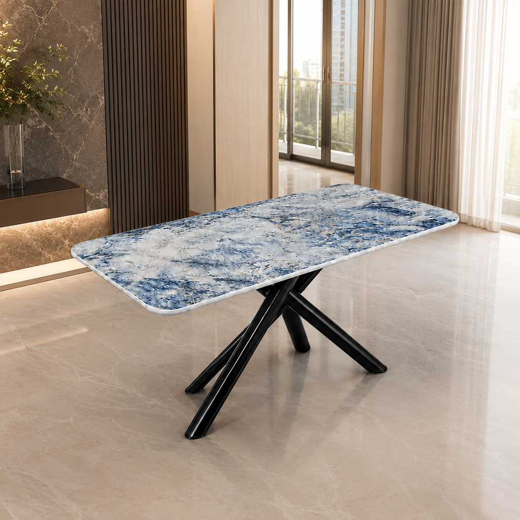 A rectangular dining table with a blue and white marbled stone-look top and black crossed metal legs, shown in a modern interior room with tiled floors and large windows.