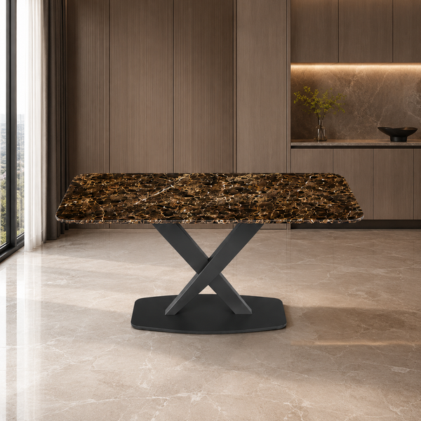 A modern rectangular dining table with a dark brown and gold marbled top and a matte black X-shaped pedestal base, set in a contemporary kitchen interior.