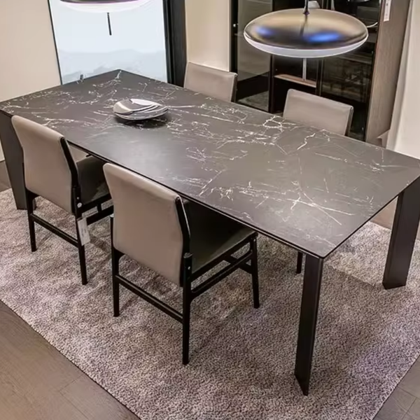 Dining table with marble-like surface and chairs in a room setting