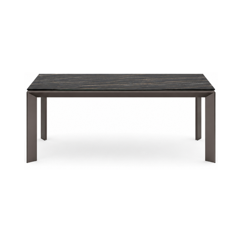 Rectangular dining table with dark marble top and bronze legs on a white background